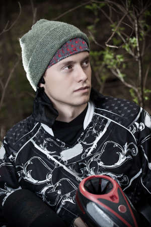 Paintball player portrait aiming with marker