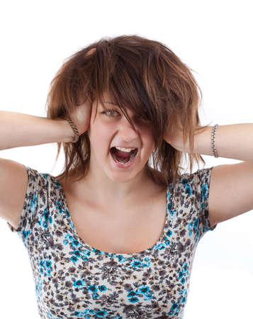 Angry woman is screaming out loud and pulling her hair. の写真素材