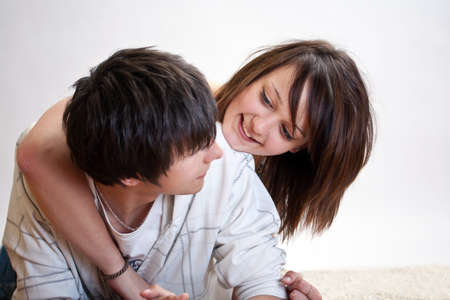 Happy young couple on the carpetの写真素材
