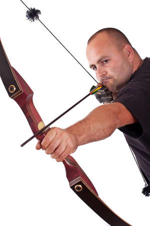 Young man in black shirt holding bow and shooting to target isolated in white