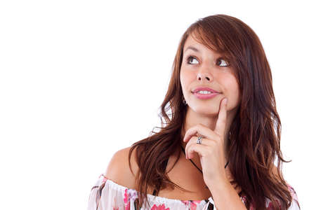Beautiful teenage girl is thinking and looking up. Isolated on white background の写真素材