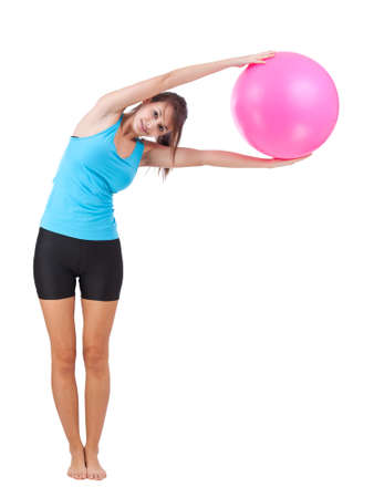 Fitness girl holding and posing with fitness ball の写真素材