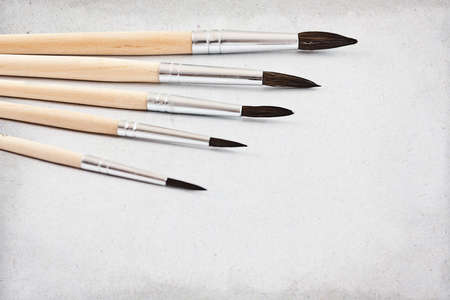Close up of different paint brushes, on grunge background の写真素材