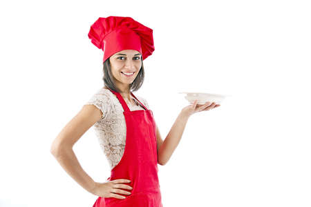 Portrait of female in chef uniform and chef hat showing plateの写真素材