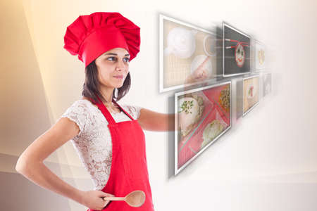 Woman dressed as a cook selecting images の写真素材
