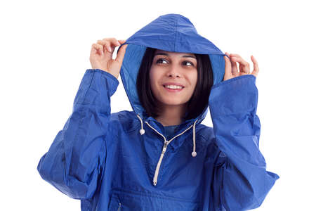 young women in a blue rain coat is looking upの写真素材
