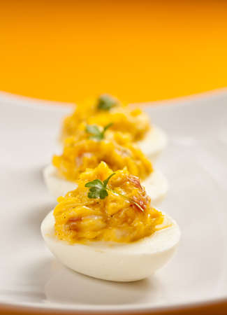 Boiled eggs cut in half and stuffed with different ingredients