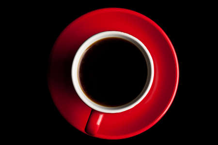 Coffee in red cup on black backgroundの写真素材
