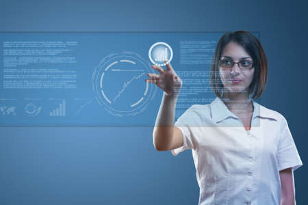 Young serious businesswoman working on modern touch screenの写真素材
