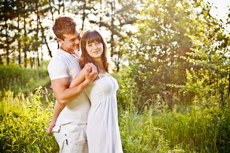 Young couple embrancing in the parkの写真素材