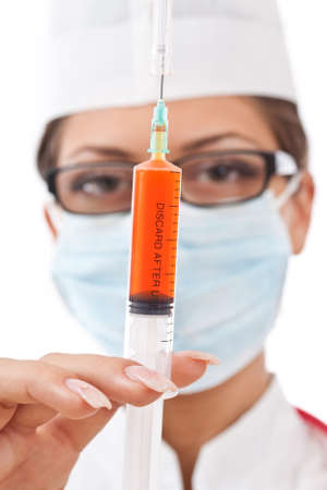 Doctor holding syringe. All on white background. の写真素材