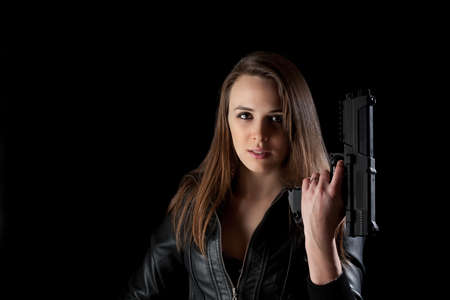 Security girl with gun. Isolated on black