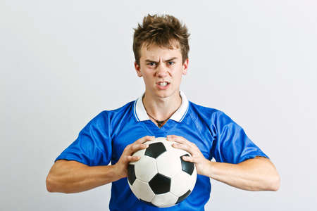 Angry soccer player with a ballの写真素材