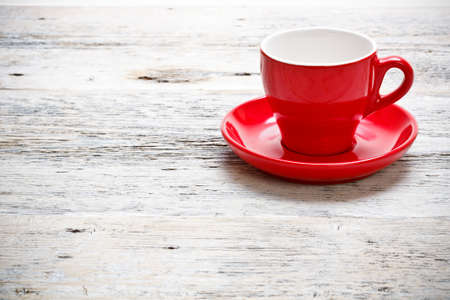 Red cup coffee on wood background 