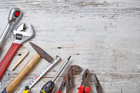 Set of different tools on wooden background 