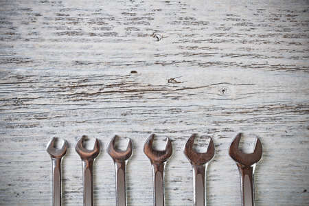 Silver spanners on wood backgroundの写真素材