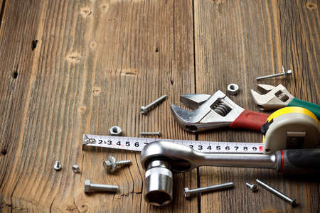 Assorted work tools on wooden panel の写真素材