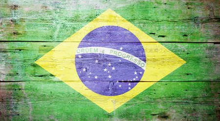 Flag of Brazil painted on grungy wood plank background の写真素材