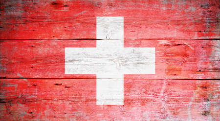 Flag of Switzerland painted on grungy wood plank background の写真素材