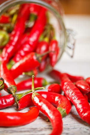 Glass jar with chili peppers の写真素材