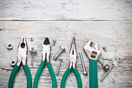 Set of tools over old wood panel with space for text 