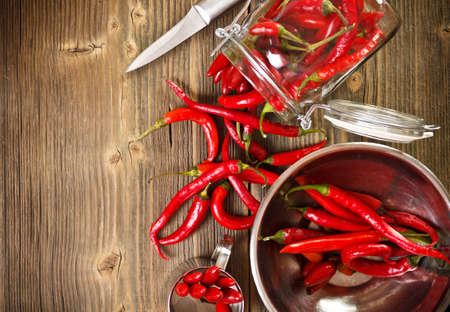 Red pepper on old wooden table surface 