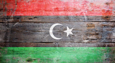 Flag of Libya painted on grungy wood plank background の写真素材