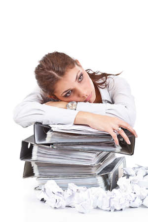Young businesswoman with tons of documents の写真素材