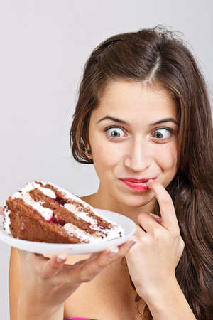 Young beautiful woman with a cakeの写真素材