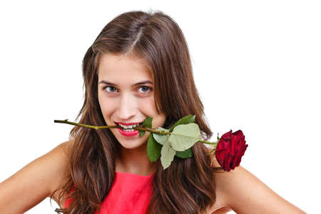 Young woman with rose in her mouthの写真素材