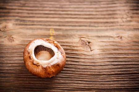 Brown champignon cap on wood table space for your textの写真素材