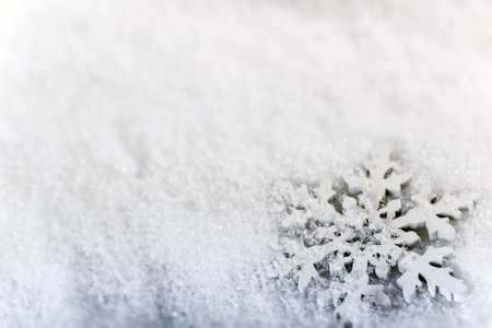 Artificial snowflake on snow background の写真素材