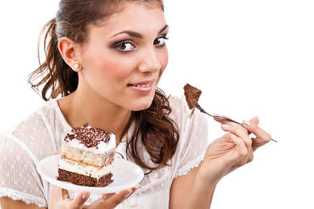 Smiling young woman with a cake slice on a plate 