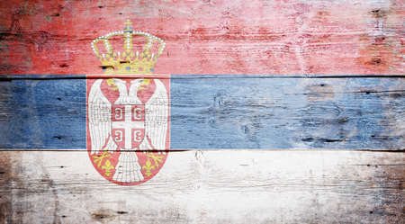Flag of Serbia painted on grungy wood plank background の写真素材