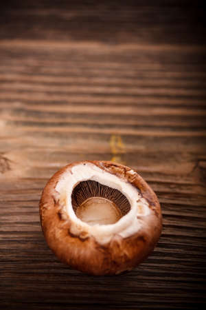 Brown mushroom on wooden backgroundの写真素材