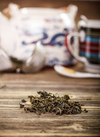 Dry green tea on wooden backgroundの写真素材