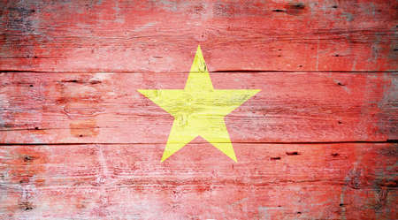 Flag of Vietnam painted on grungy wood plank background の写真素材