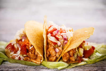 Tacos with lettuce, cheese and tomato の写真素材