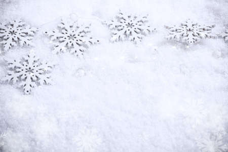 Winter holiday background, snowflakes border over snow.の写真素材