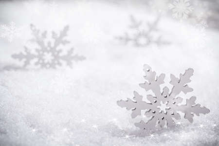 Winter background, artificial snowflakes on snow