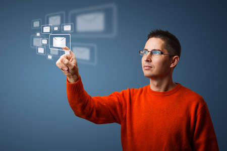 Young man pressing modern touch screen buttons 
