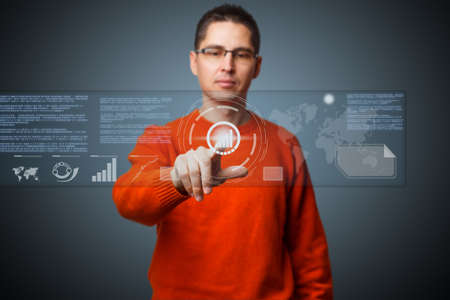 Young man navigating holographic virtual reality interface. の写真素材