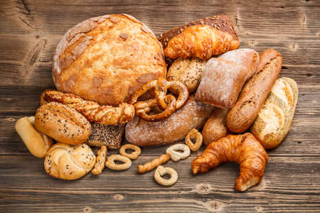 Large variety of baked goods on old wooden backgroundの写真素材