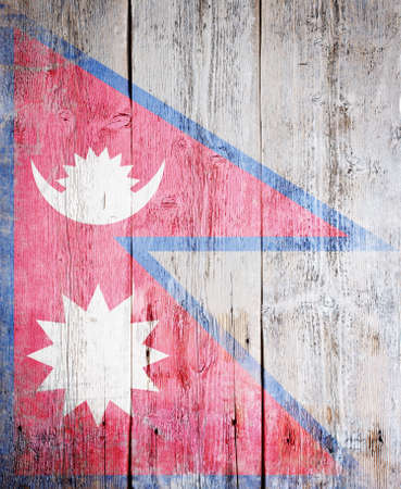 Flag of Nepal painted on grungy wood plank background の写真素材