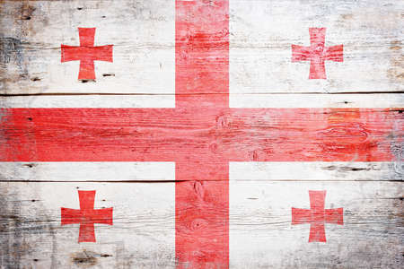 Flag of Georgia painted on grungy wood plank background の写真素材