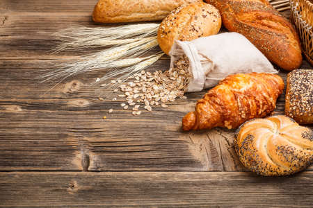 Different types of baked goods on wooden backgroundの写真素材