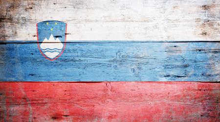 Flag of Slovenia painted on grungy wood plank background の写真素材