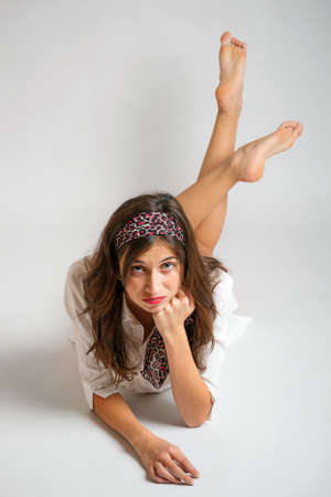 Portrait of young woman lying o floor の写真素材