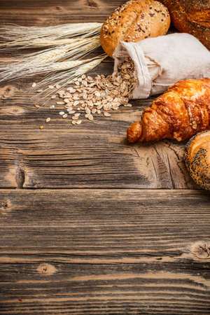Fresh croissant on old wooden table の写真素材