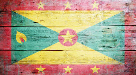 Flag of Grenada painted on grungy wood plank background の写真素材